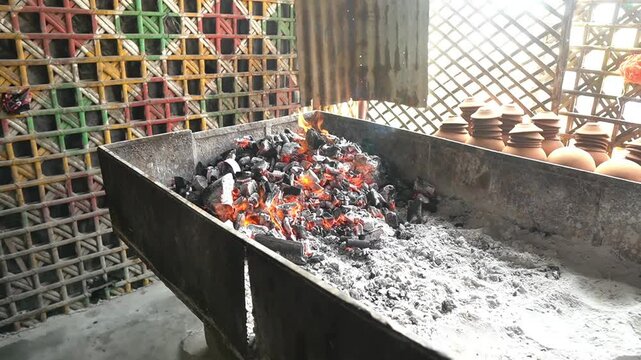 Burning of charcoal for cooking of handi mutton recipe.