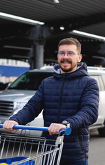 Young guy with a grocery cart