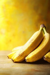 A pile of bananas on a podium against yellow background