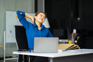 Female businessman is doing a stretchy posture due to sitting in the office for too long, office...