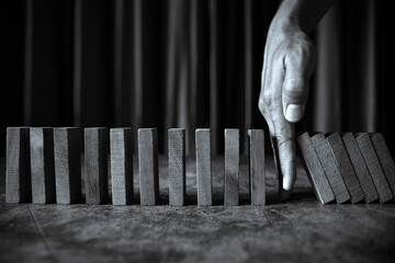 Hand stop wooden block stack concept of team building of prevent not collapse or crash of financial...