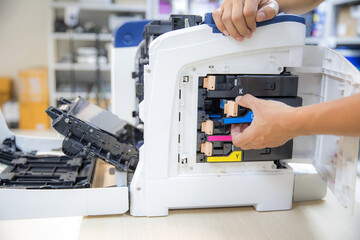Technician Holding ink printer toner low for replace new or fix repair problem paper or print...