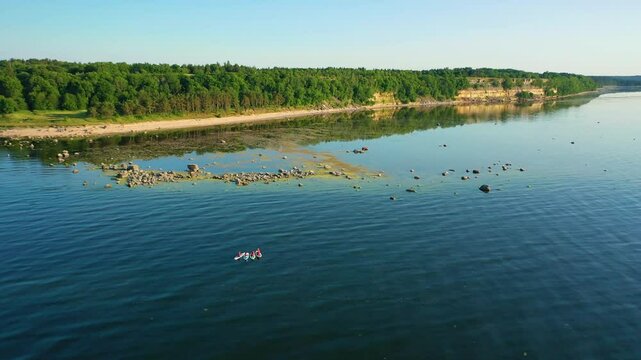 People row canoes on the lake .Aerial 4K video from drone .Estonia, Paldiski. (Series)