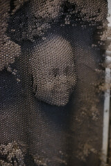 A three-dimensional convex face print. Sculpture of a portrait made of small particles