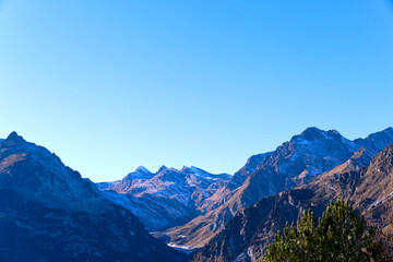 Mountain panorama in the Swiss Alps seen from mountain village of Maloja on a sunny autumn day. Photo taken November 15th, 2024, Maloja Bregaglia, Switzerland.