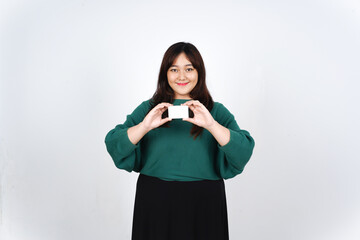 Holding Credit Debit Card, Smiling and showing white blank card, Pay or Shopping Concept Of Beautiful Asian Woman wearing green Isolated On White Background