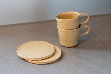 Handmade ceramic coffee or tea mugs on wooden surface. High quality photo