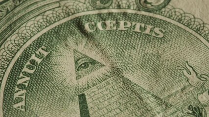 Close up of the Eye of Providence on United States dollar bill. Illuminati and conspiracy theories concept - Powered by Adobe