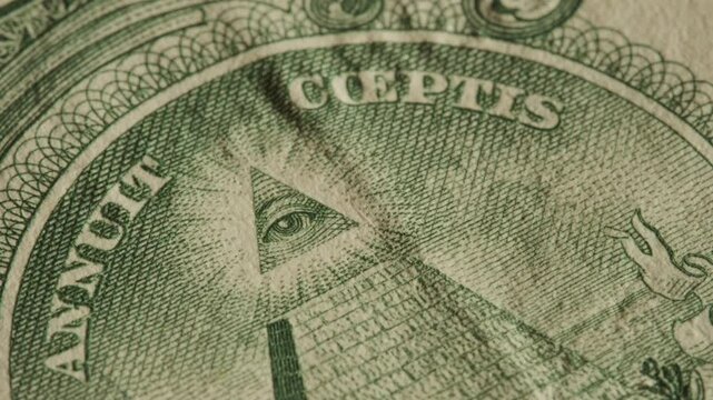 Close up of the Eye of Providence on United States dollar bill. Illuminati and conspiracy theories concept