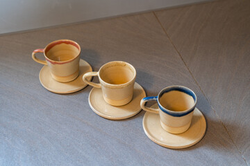 Handmade ceramic coffee or tea mugs on wooden surface. High quality photo