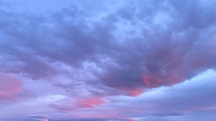 A beautiful evening sky with soft lilac clouds and sunset hues.