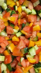 Salad with tomatoes, cucumbers, and bell peppers, top view.