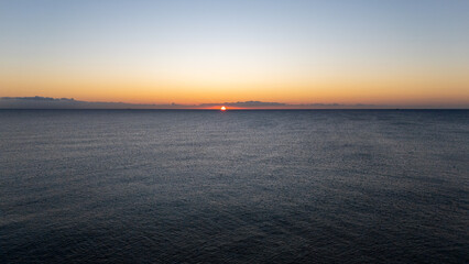 Drone aerial view of sea during sunrise