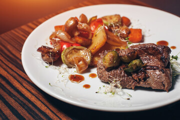 grilled fresh vegetables with meat and rosemary on wooden table