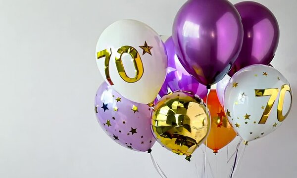 Festive arrangement of golden and purple balloons with star patterns celebrating a 70th milestone event