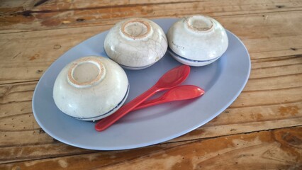 Thai dessert (khanom thuay) coconut milk custard in small porcelain cup .