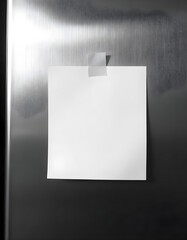 Isolated Blank Paper Note Centered on Stainless Steel Fridge with Adhesive Tape and Soft Kitchen Lighting Reflections