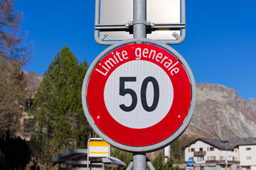 Close-up of traffic sign speed limit 50 at Swiss mountain village of Maloja on a sunny autumn day....