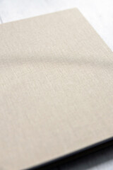 Close-up of textured light cover of luxury book, book covers, beige texture, book, photo album.