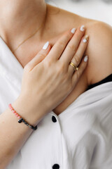 Woman's hand with wrist bracelet, bracelet with natural stones, handmade jewelry, gift idea for a woman, artistic gel nails, smooth hand skin.