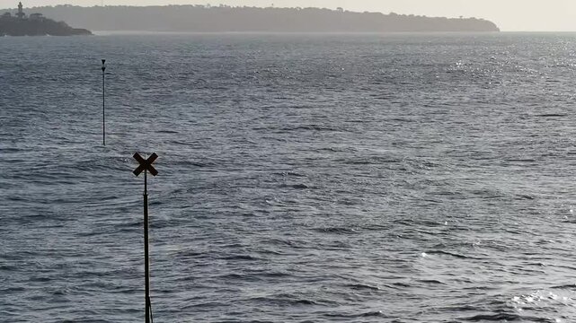 Ocean Waves Moving Past Marine Signs on the Atlantic Coast in Royan
