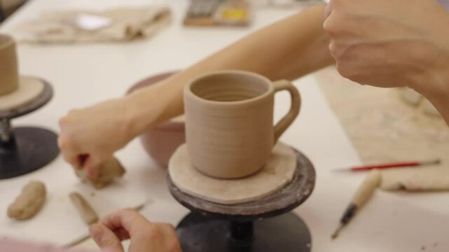 Crafting a clay mug at a local pottery studio in the afternoon