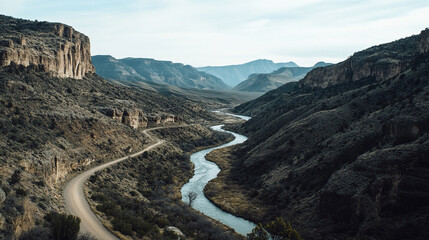 Scenic river winding through rugged mountains in an expansive valley during daytime