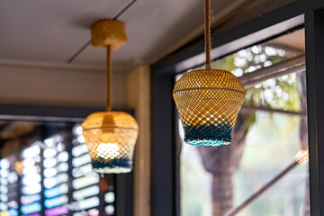 Handwoven Bamboo Pendant Lamps with Blue Glass Accents in Cozy Interior