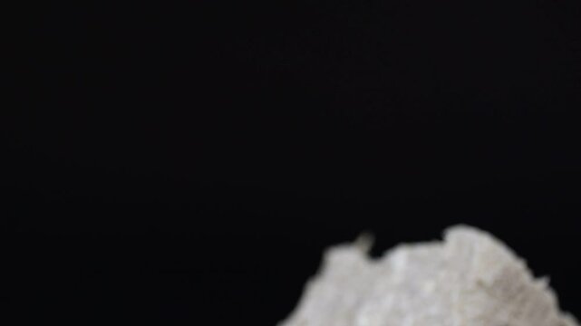 Detailed close-up of halva and other traditional sweets spinning.