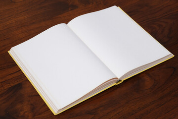 A book with empty page on wooden table