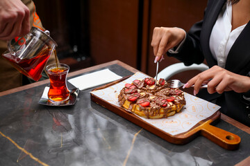 Enjoying a delicious dessert while sipping tea in a cozy cafe
