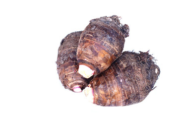 Fresh organic taro roots isolated on white background. Concept, edible plant root that can be cooked for many delicious menu of food and dessert. Agricultural crops.    