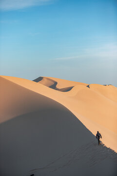 Khongor Sand Dunes in the Gobi Desert of Mongolia. Vast golden sand dunes stretching across the desert landscape, surrounded by mountains and showcasing the unique beauty of one of Mongolia&rsquo;s most ico