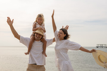 Family happy relaxing on beach children mother father travel summer vacation together sea holiday tropical Sunset time. Trip enjoying bonding. Family day having fun.