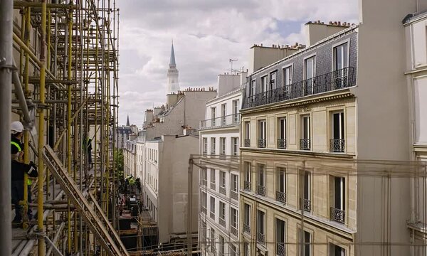 Construction site with scaffolding and buildings in Paris.