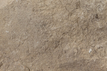 Textured brown stone surface with subtle details and rugged imperfections.