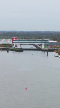 temse&rsquo;s riverside apartment buildings boelwerf crane scene luxury homes river scheldt panning shot temse belgium residential properties scenic view riverfront waterfront 