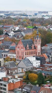temse focuses church city hall middle town residential area river scheldt add to picturesque setting aerial belgium drone view cityscape riverfront scenic footage scene 