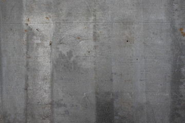 Rough metallic surface with gray tones and weathered imperfections.