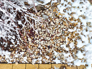 Textured landscape of pebbles and snow in a serene outdoor setting during winter