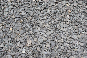 A collection of gray gravel stones with rough textures and uneven shapes.