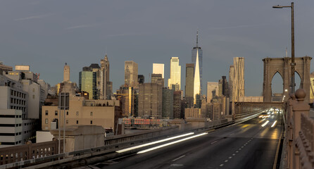 cars driving over the brooklyn bridge from manhattan new york city (long exposure light trails)...