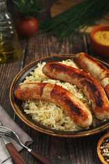 A bowl with Bratwurst and Sauerkraut as side dish - traditional German food