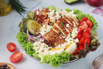 A bowl with cobb salad, traditional American dish