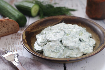 A traditional Polish salad Mizeria in rustic style	