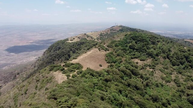 Aerial flyover of the Ngong Hills in Kenya with Nairobi in the background.