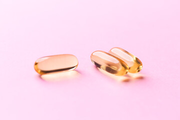 Fish oil capsules with omega 3 on bright background. Concept for a healthy dietary supplementation. Immune System Support. Soft focus. Close up. Copy space.
