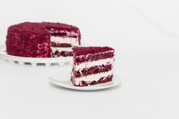 Red Velvet Cake is a traditional red chocolate cake with white buttercream on white background
