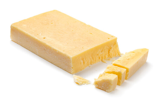 Extra mature english traditional cheddar cheese and pieces isolated on white background close up