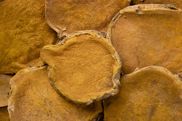 Dried Temulawak slices full frame close up as background